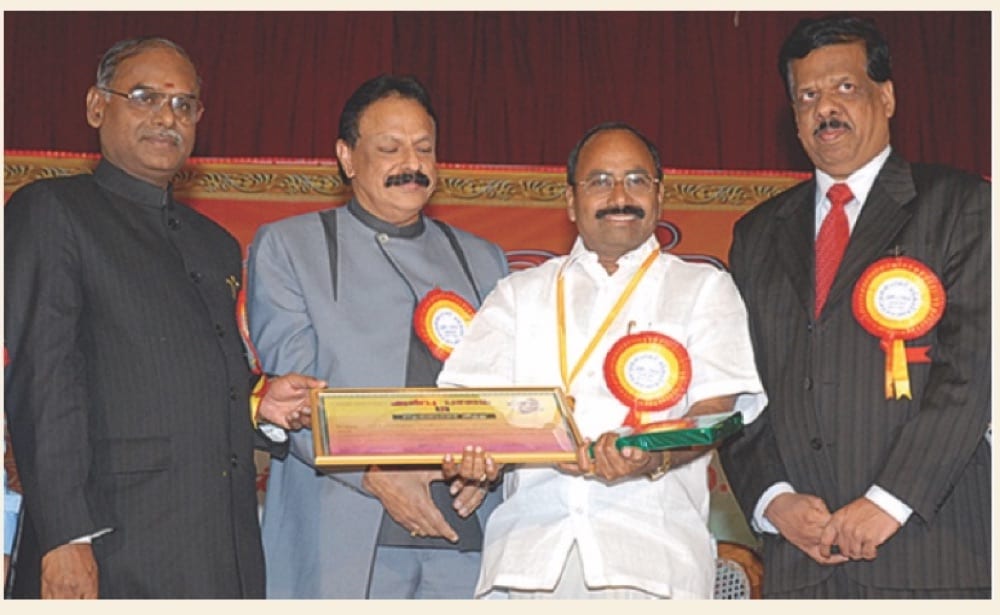 Prof. Dr. M. Karunanithi receiving the Achiever in Women Education